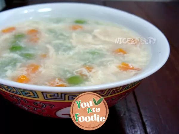 Colorful vegetable soup with shredded chicken and egg