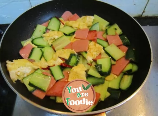 Fried ham and egg with cucumber